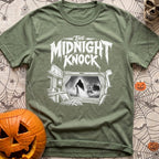 Fear The Knock - T-Shirt in Moss - A black and white illustration looking from the inside of a camper out the window,...