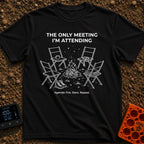 My Only Meeting - T-Shirt in Black - A white line illustration of four empty camp chairs arranged around a campfire under...