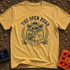 Roads Over Meetings - T-Shirt in Mustard - A heraldic crest design featuring a mountain range with pine trees, a steering...