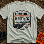 Roadtrips Not Meetings - T-Shirt in Bay - A crest-style design featuring a white camper van driving on a mountain road...