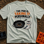 Skillet's Grudge Match - T-Shirt in Bay - An illustration of a cast iron skillet holding a severely burnt pancake,...