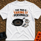 Skillet's Grudge Match - T-Shirt in White - An illustration of a cast iron skillet holding a severely burnt pancake,...
