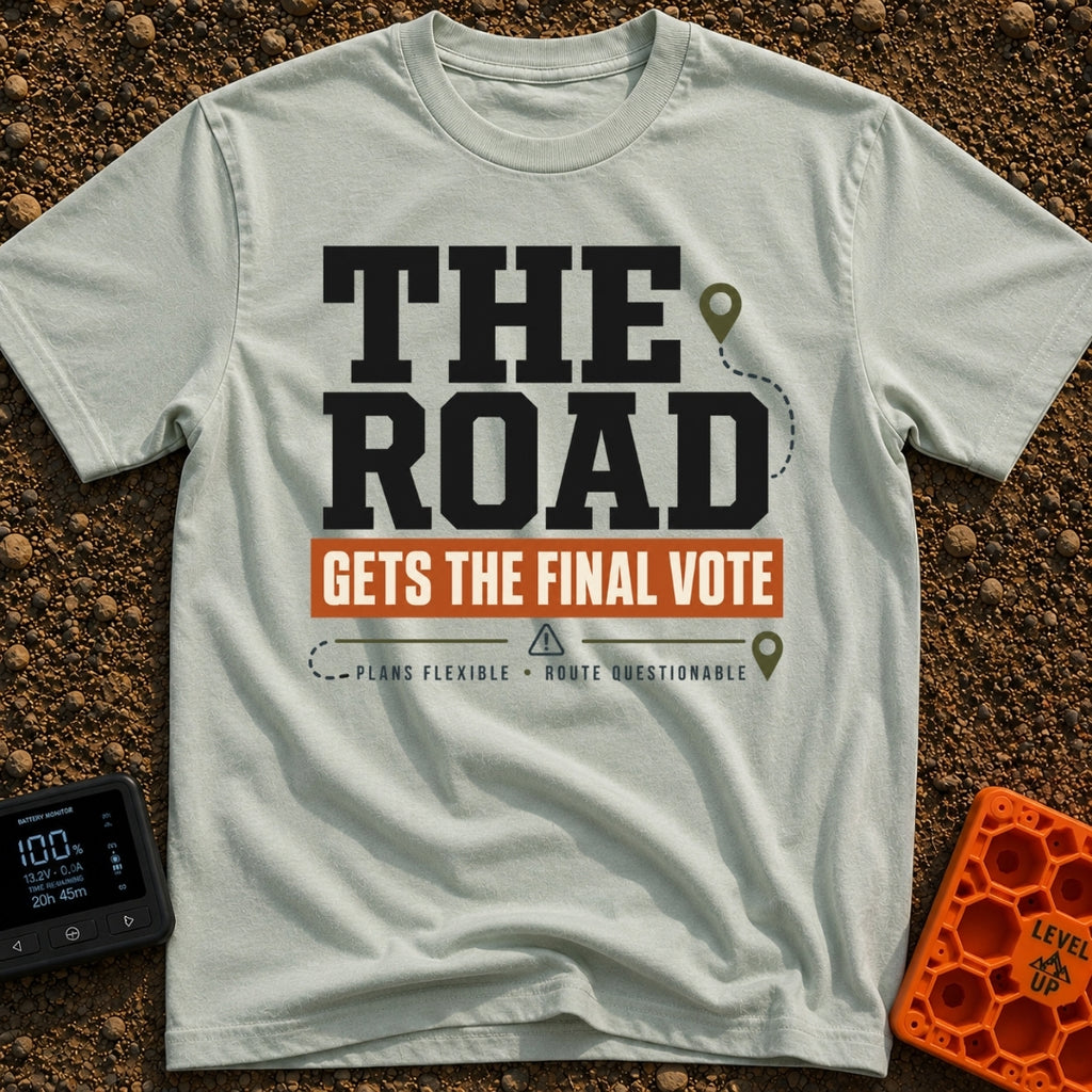 The Road Votes Last - T-Shirt in Bay - A typographic design featuring the large text "THE ROAD" above a brown banner...