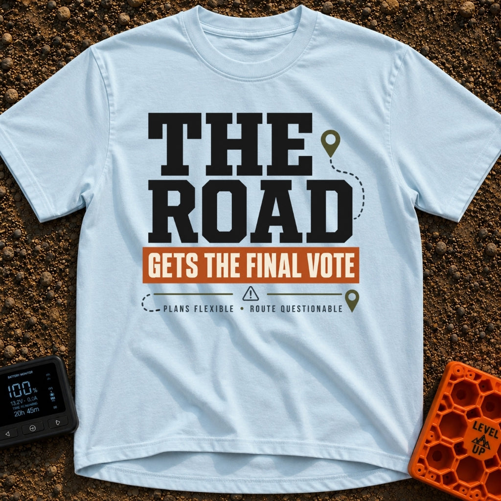 The Road Votes Last - T-Shirt in Chambray - A typographic design featuring the large text "THE ROAD" above a brown banner...