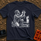In Bubble We Trust - T-Shirt in Navy - A white line-art illustration showing a bearded man kneeling beside a camper...