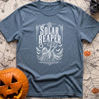 Reap What You Sun - T-Shirt in Blue Jean - A black-and-white, vintage-style illustration of the Grim Reaper holding a...