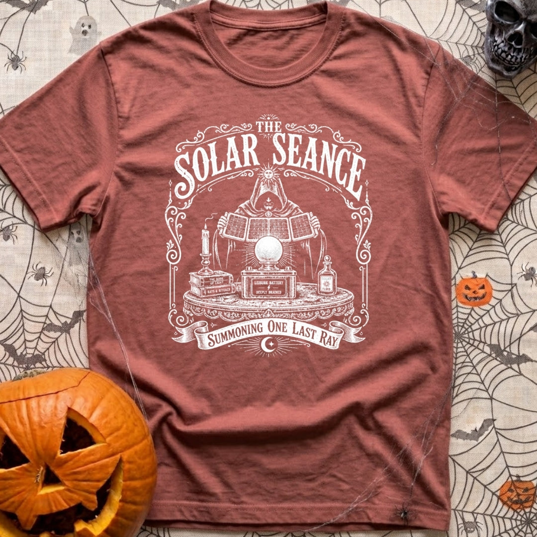 The Solar Seance - T-Shirt in Brick - A vintage-style white line drawing of a hooded figure holding up foldable solar...