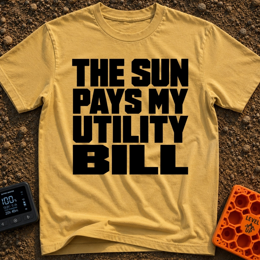 Sun Pays My Bills - T-Shirt in Mustard - A text-only design featuring the phrase "THE SUN PAYS MY UTILITY BILL" in large,...