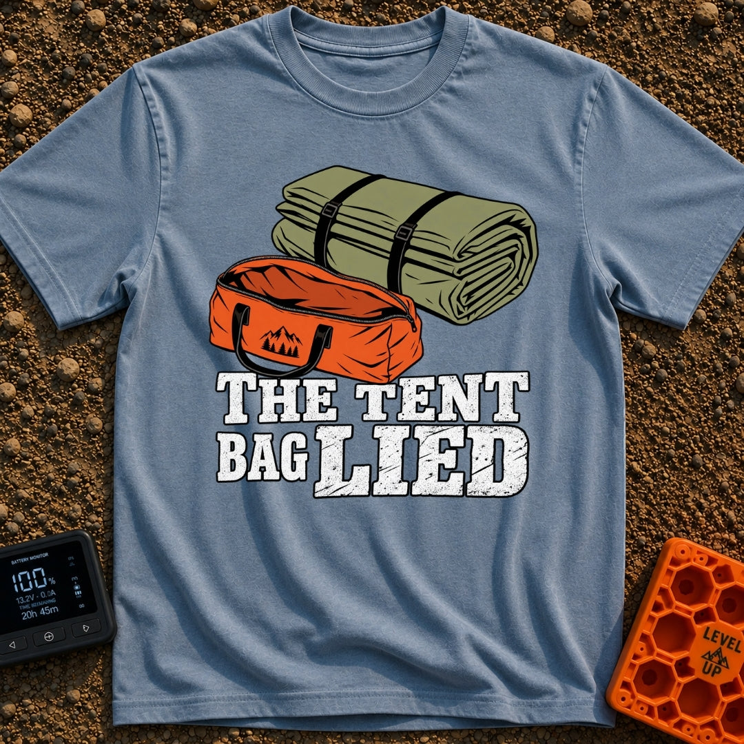 The Tent Bag Lied - T-Shirt in Blue Jean - A graphic showing a large rolled-up green tent sitting next to a noticeably...