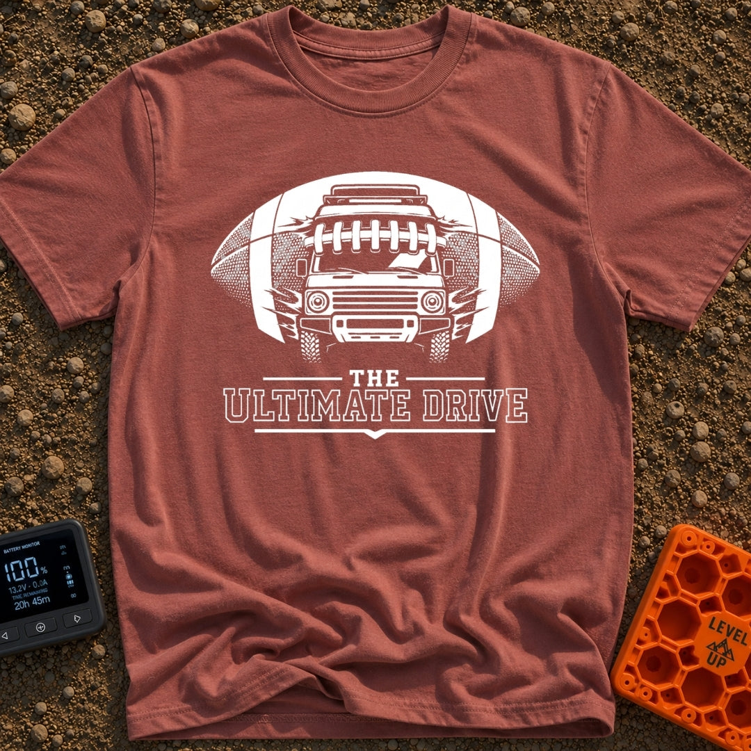 The Ultimate Drive - T-Shirt in Brick - A black and white illustration of a camper van breaking through the center of a...