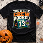 The Whole Crew Booked - T-Shirt in Black - A typographic design reading 'THE WHOLE CREW BOOKED', above a teal campsite...