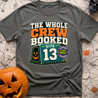 The Whole Crew Booked - T-Shirt in Pepper - A typographic design reading 'THE WHOLE CREW BOOKED', above a teal campsite...