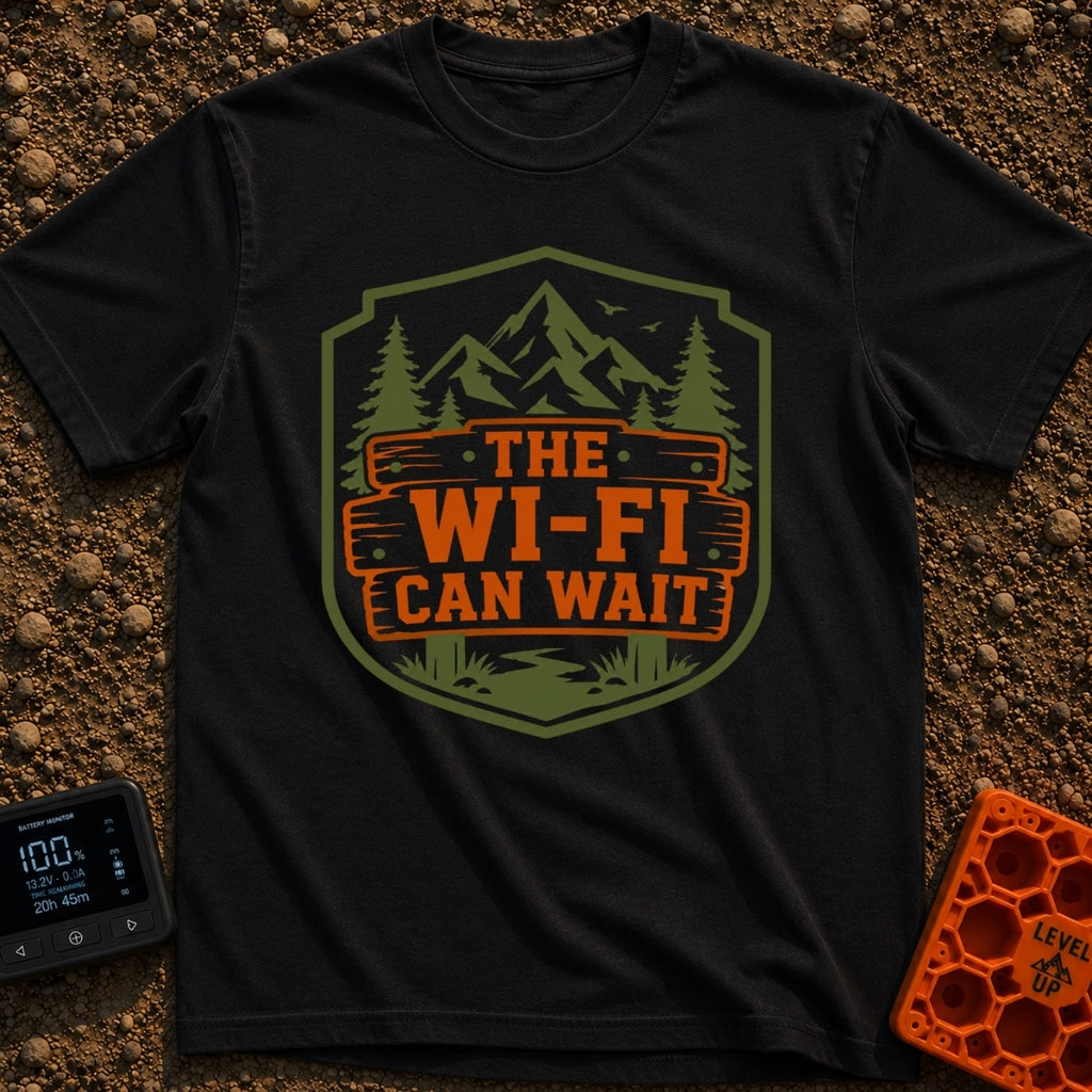 Mountains Over Modems - T-Shirt in Black - A badge-shaped graphic featuring green mountains, pine trees, and a winding...
