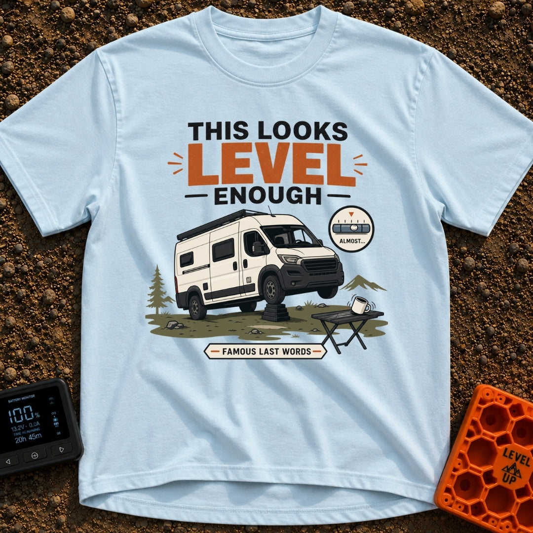 Leaning Tower Camper - T-Shirt in Chambray - A cartoon illustration of a white camper van parked on uneven terrain with...