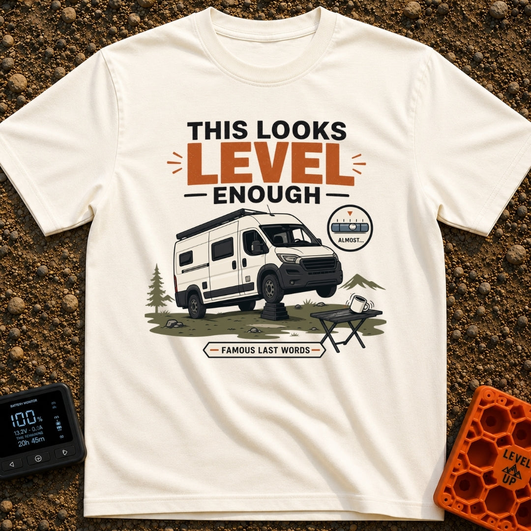 Leaning Tower Camper - T-Shirt in Ivory - A cartoon illustration of a white camper van parked on uneven terrain with its...