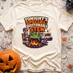 Tonights Questionable Stew - T-Shirt in Ivory - A cartoon skeleton wearing a beanie and vest sits in a camp chair holding...