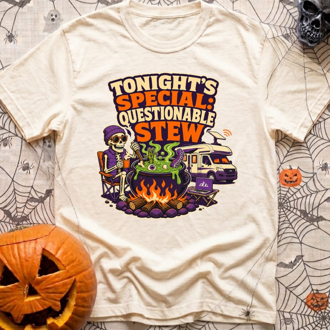Tonights Questionable Stew - T-Shirt in Ivory - A cartoon skeleton wearing a beanie and vest sits in a camp chair holding...
