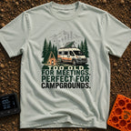 Too Old For Meetings - T-Shirt in Bay - A camper van with a tilted solar panel on its roof parked next to a green tent, a...