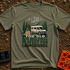 Too Old For Meetings - T-Shirt in Moss - A camper van with a tilted solar panel on its roof parked next to a green tent,...
