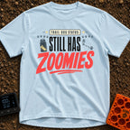 Still Has Zoomies - T-Shirt in Chambray - A typography-based design reading "TRAIL DOG STATUS: STILL HAS ZOOMIES" with...
