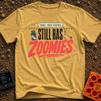 Still Has Zoomies - T-Shirt in Mustard - A typography-based design reading "TRAIL DOG STATUS: STILL HAS ZOOMIES" with...