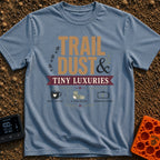 Dust And Tiny Luxuries - T-Shirt in Blue Jean - The design displays the typographic text "TRAIL DUST & TINY LUXURIES"...
