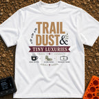 Dust And Tiny Luxuries - T-Shirt in White - The design displays the typographic text "TRAIL DUST & TINY LUXURIES"...