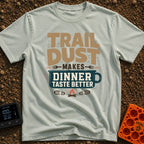 Seasoned With Trail Dust - T-Shirt in Bay - A typographic design reading "TRAIL DUST MAKES DINNER TASTE BETTER" with the...