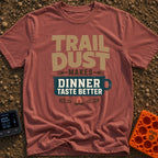 Seasoned With Trail Dust - T-Shirt in Brick - A typographic design reading "TRAIL DUST MAKES DINNER TASTE BETTER" with...