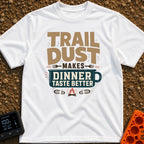 Seasoned With Trail Dust - T-Shirt in White - A typographic design reading "TRAIL DUST MAKES DINNER TASTE BETTER" with...