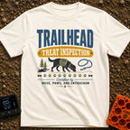 Will Hike For Treats - T-Shirt in Ivory - A graphic design featuring the text "TRAILHEAD TREAT INSPECTION" above a...