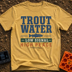 Trout Tranquility Zone - T-Shirt in Mustard - A typographic design featuring the text "TROUT WATER" in large blue letters...