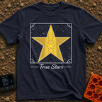 Follow The True Stars - T-Shirt in Navy - A large gold, five-pointed star featuring a vertical tire track pattern running...