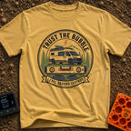 Level Ground Legends - T-Shirt in Mustard - A circular badge illustration showing a white camper van with a roof-mounted...
