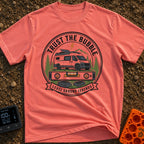 Level Ground Legends - T-Shirt in Watermelon - A circular badge illustration showing a white camper van with a...