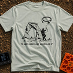 USB Rodeo Wrangler - T-Shirt in Bay - A black and white illustration of a cowboy leaning against a large natural rock...