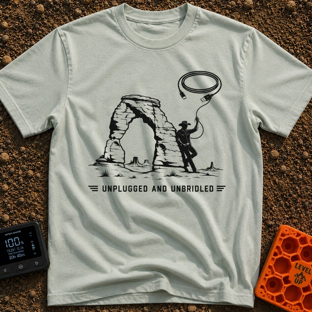 USB Rodeo Wrangler - T-Shirt in Bay - A black and white illustration of a cowboy leaning against a large natural rock...
