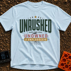 Unplugged And Unbothered - T-Shirt in Chambray - A typographic design featuring the words "UNRUSHED UNOWNED UNPLUGGED"...