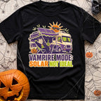 Solar Sucks For Vampires - T-Shirt in Black - A cartoon illustration of a vampire relaxing in a camp chair holding a...