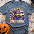 Solar Sucks For Vampires - T-Shirt in Blue Jean - A cartoon illustration of a vampire relaxing in a camp chair holding a...