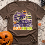 Solar Sucks For Vampires - T-Shirt in Espresso - A cartoon illustration of a vampire relaxing in a camp chair holding a...