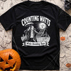 The Vampires Dilemma - T-Shirt in Black - A line drawing of a vampire standing in a desert landscape, holding a parasol...