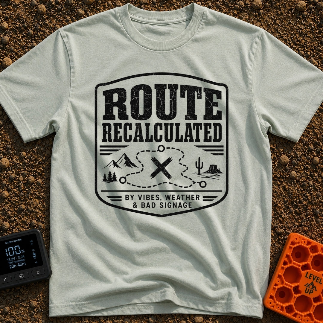 Navigating By Vibes - T-Shirt in Bay - A black and white distressed badge design featuring the text "ROUTE RECALCULATED"...
