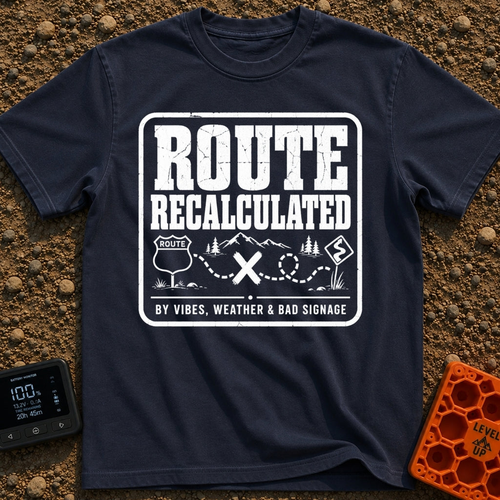 Navigating By Vibes - T-Shirt in Navy - A black and white distressed badge design featuring the text "ROUTE RECALCULATED"...