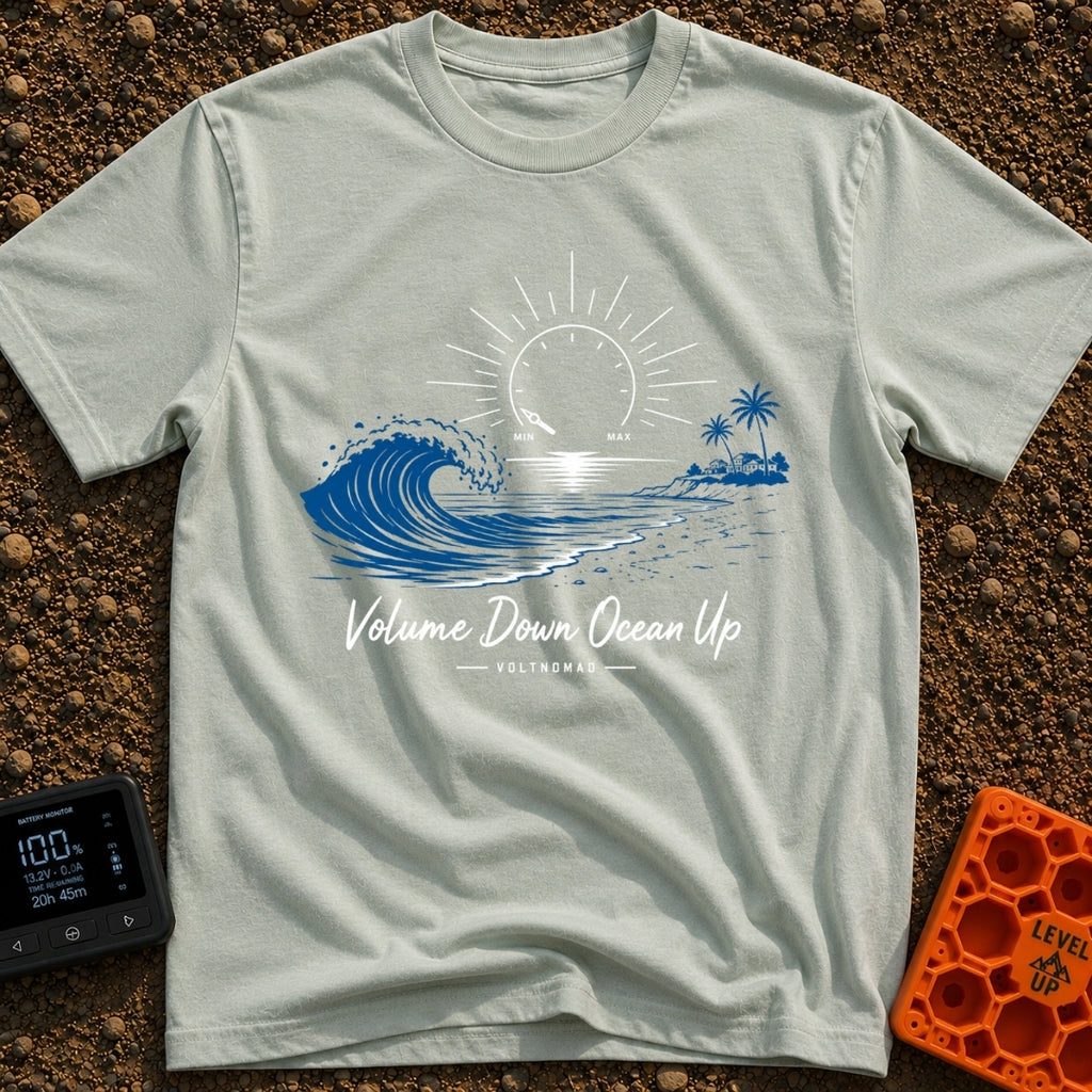 Wave Volume Control - T-Shirt in Bay - A graphic illustration featuring a large blue ocean wave on the left and a sandy...