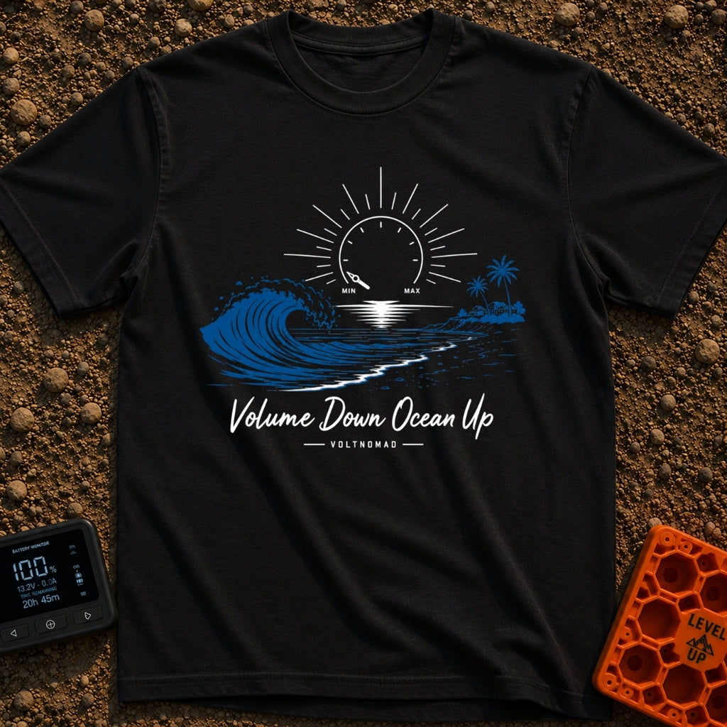 Wave Volume Control - T-Shirt in Black - A graphic illustration featuring a large blue ocean wave on the left and a sandy...