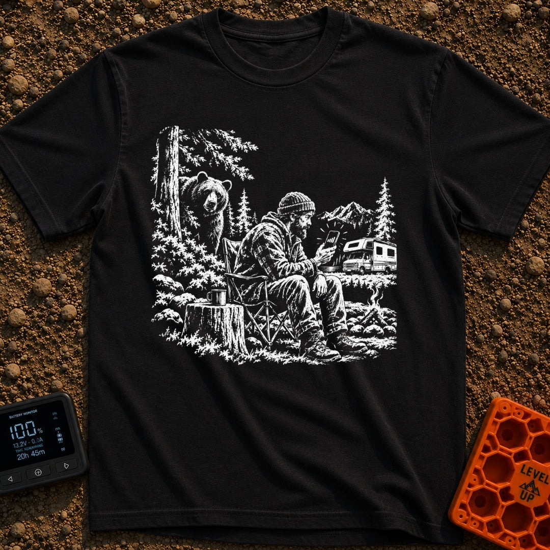 Meet The Locals - T-Shirt in Black - A black and white illustration of a man sitting by a campfire looking at his...