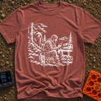 Meet The Locals - T-Shirt in Brick - A black and white illustration of a man sitting by a campfire looking at his...