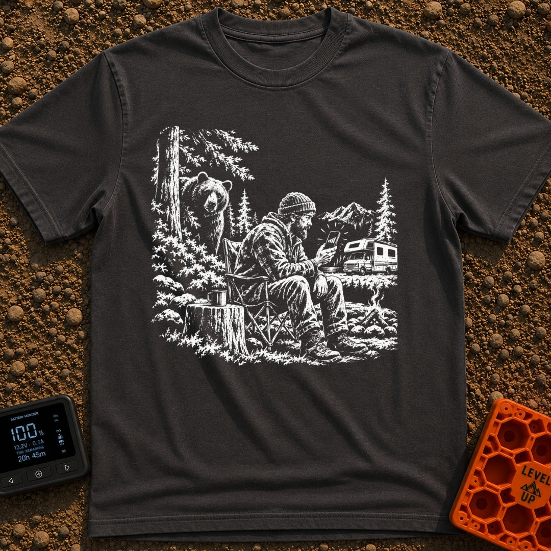 Meet The Locals - T-Shirt in Graphite - A black and white illustration of a man sitting by a campfire looking at his...