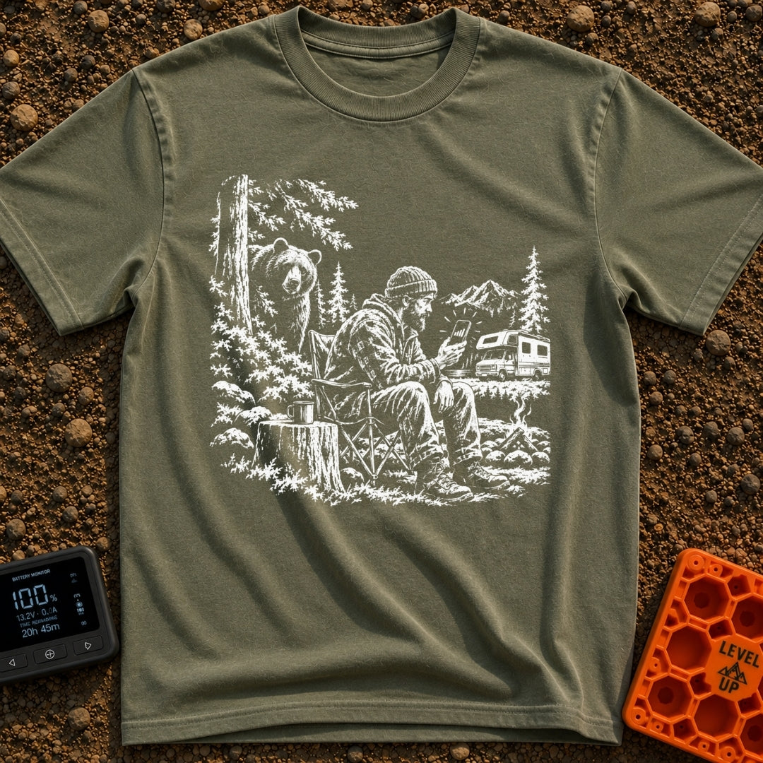 Meet The Locals - T-Shirt in Moss - A black and white illustration of a man sitting by a campfire looking at his...